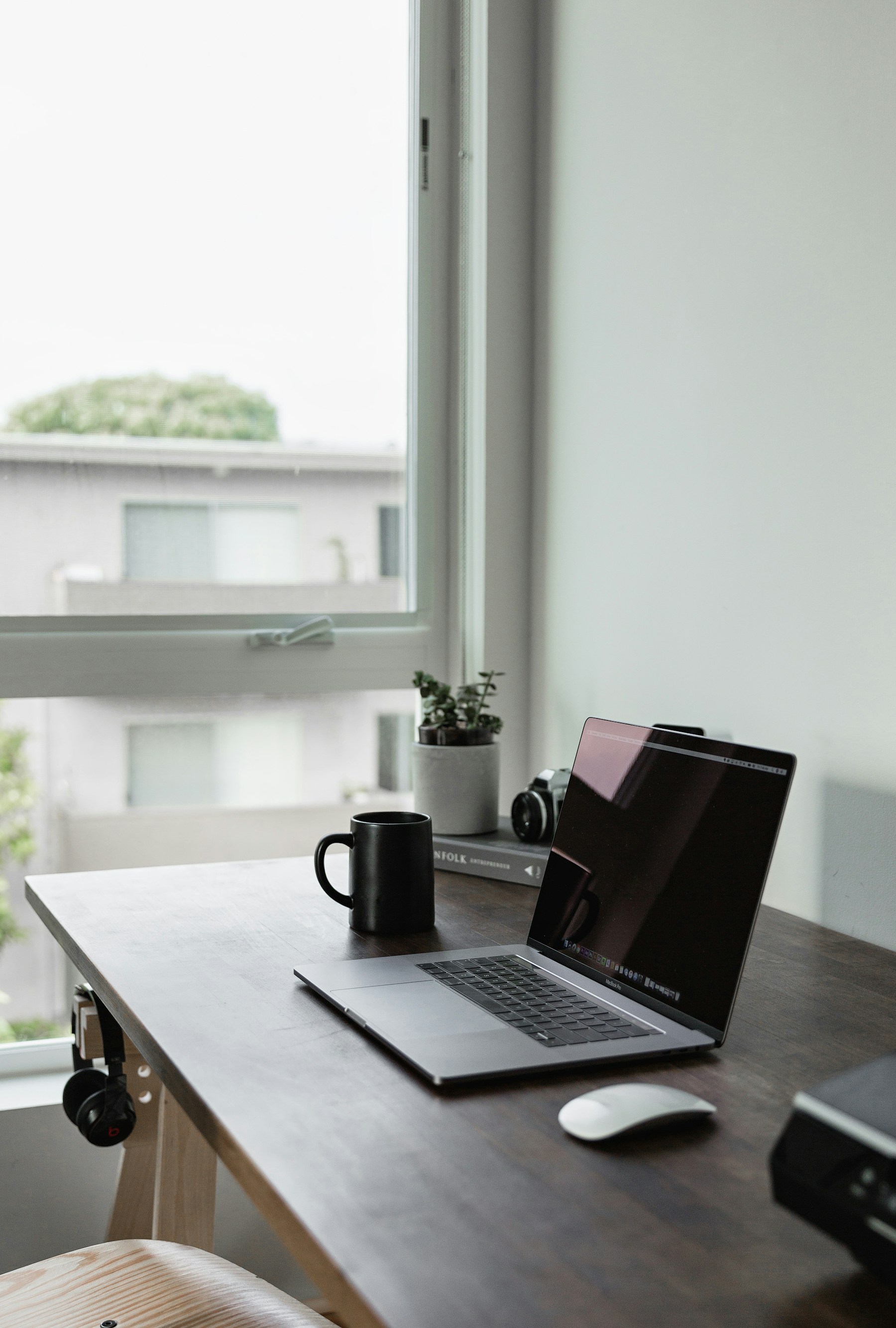 MacBook at a desk workspace — monitoring battery performance and energy usage per app